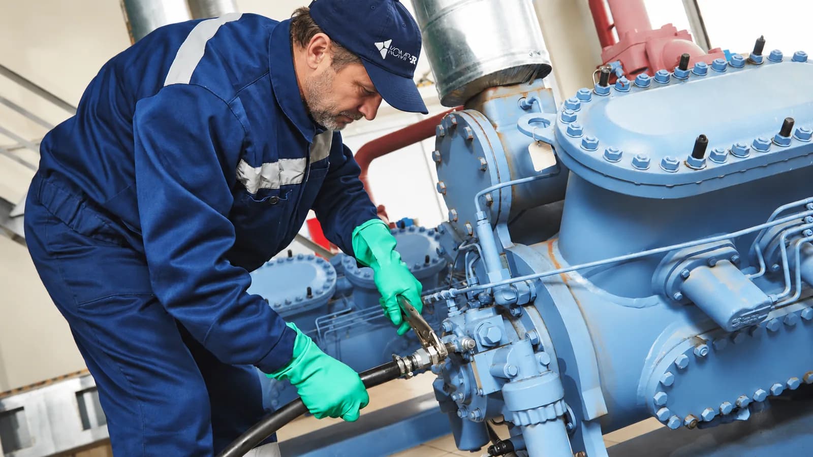 KOMP-R service technician servicing a compressor